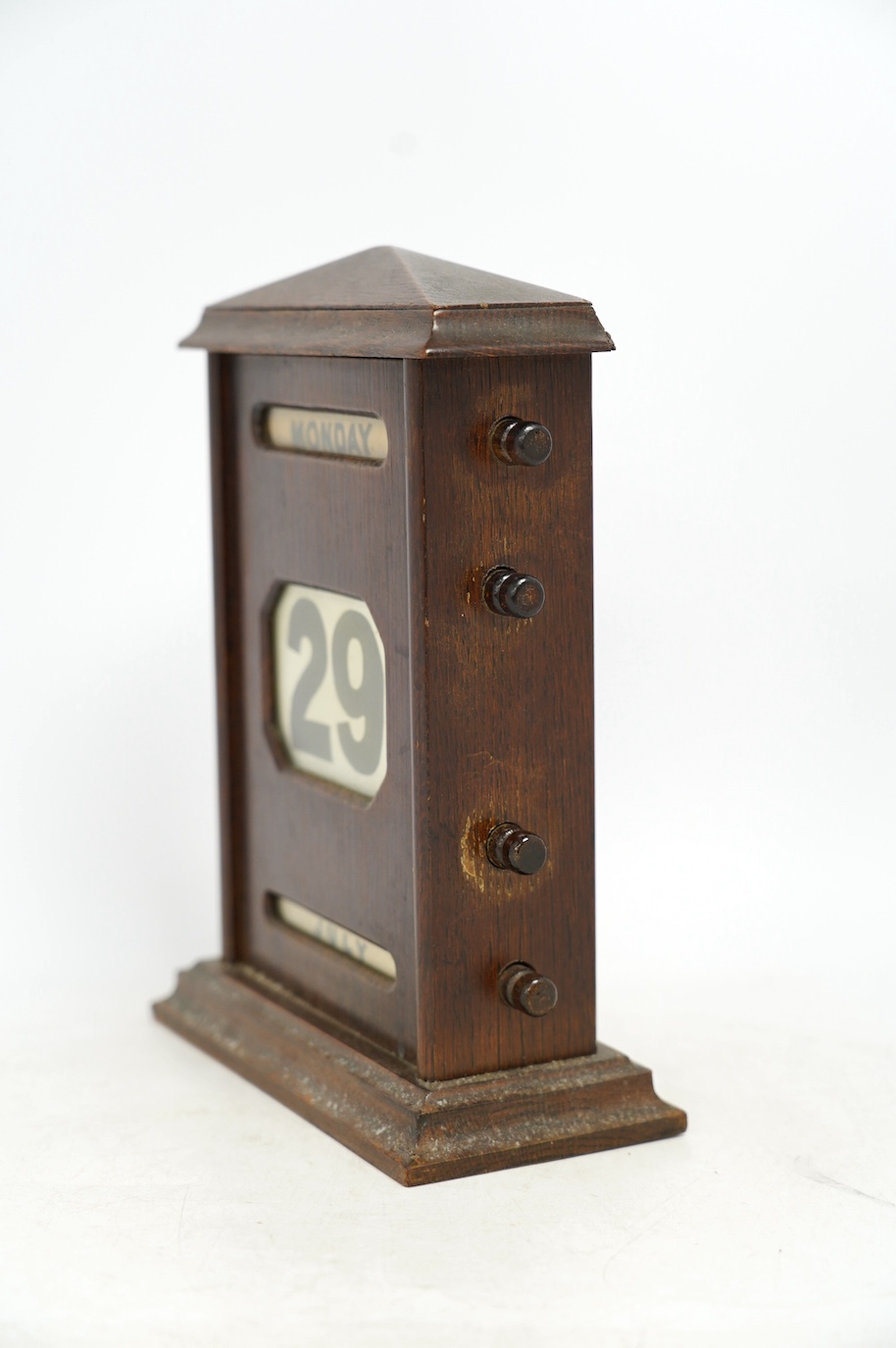 An early 20th century oak perpetual calendar, 19cm wide, 26cm high. Condition - fair